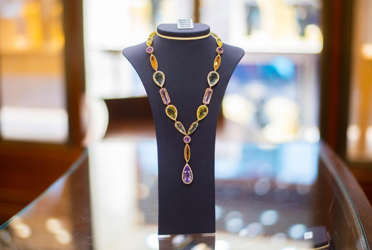 Multi-coloured quartz and diamond necklace on a navy velvet display stand at Dipples Bury St Edmunds, 22,950 pounds